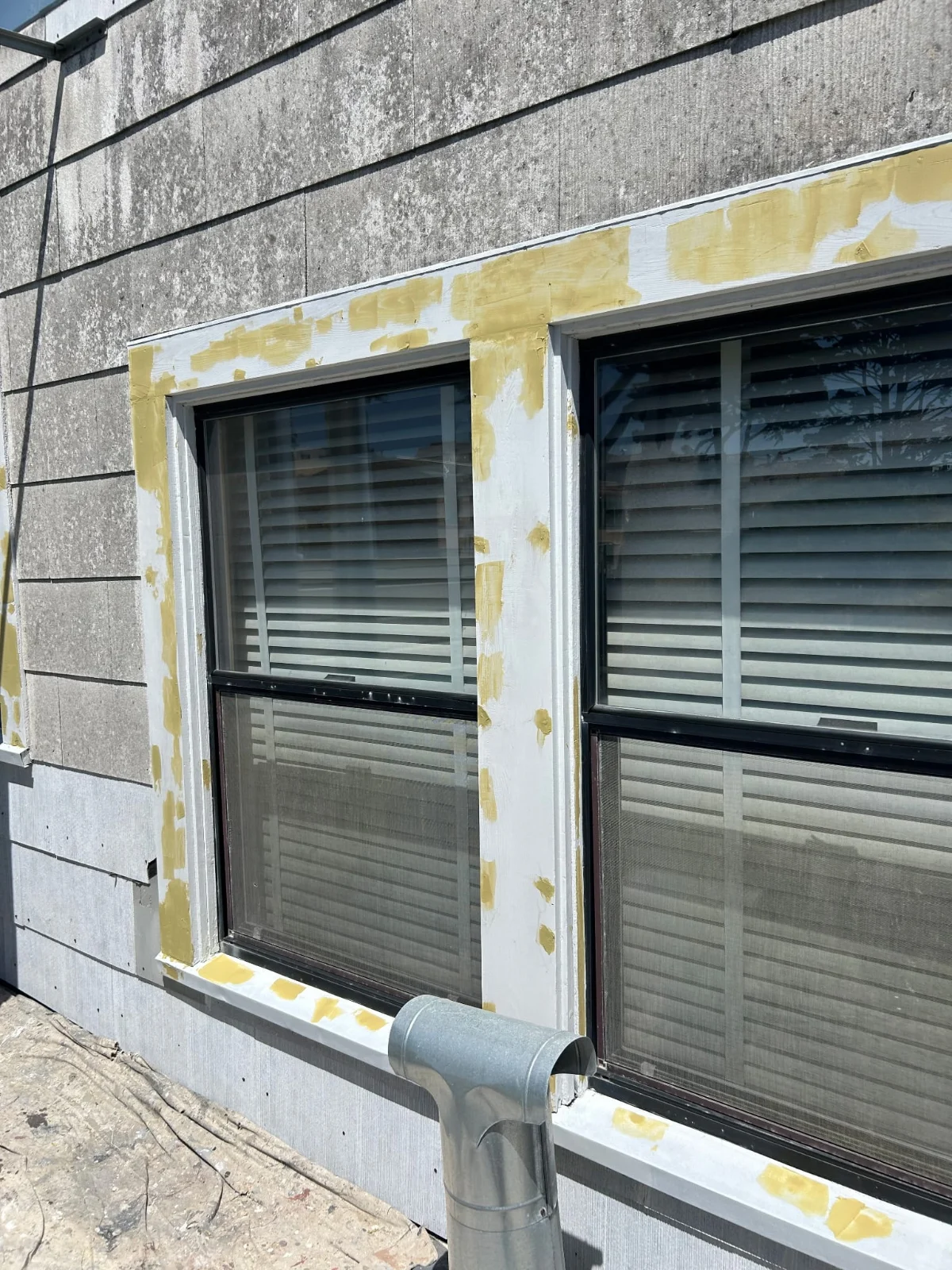 Window trim patched with wood filler and primer